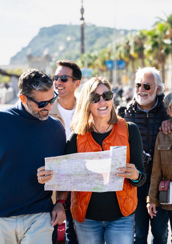 Group of tourists walking and checking city map looking for landmark destination
